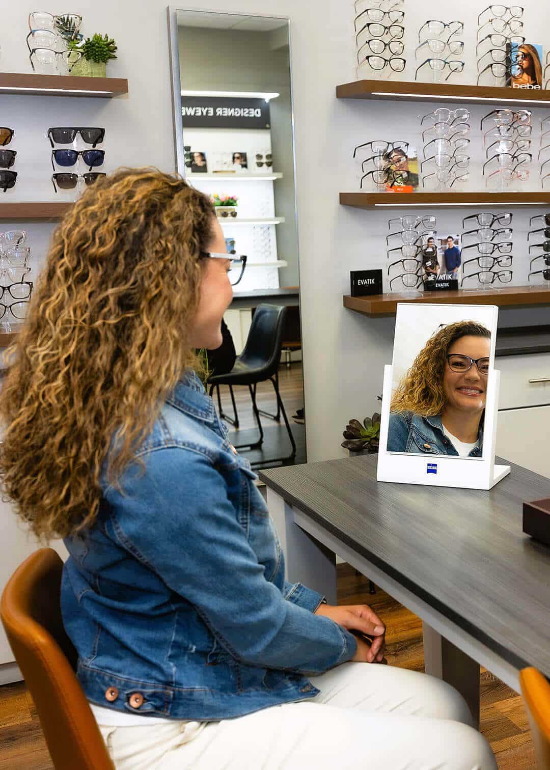 Happy Young Woman Trying on Glasses