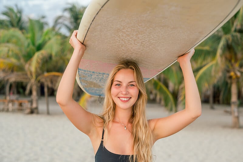 Woman Carrying a Surf Board